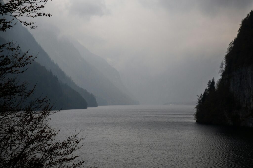 Foggy mountain lake with serene mist and peaceful atmosphere.